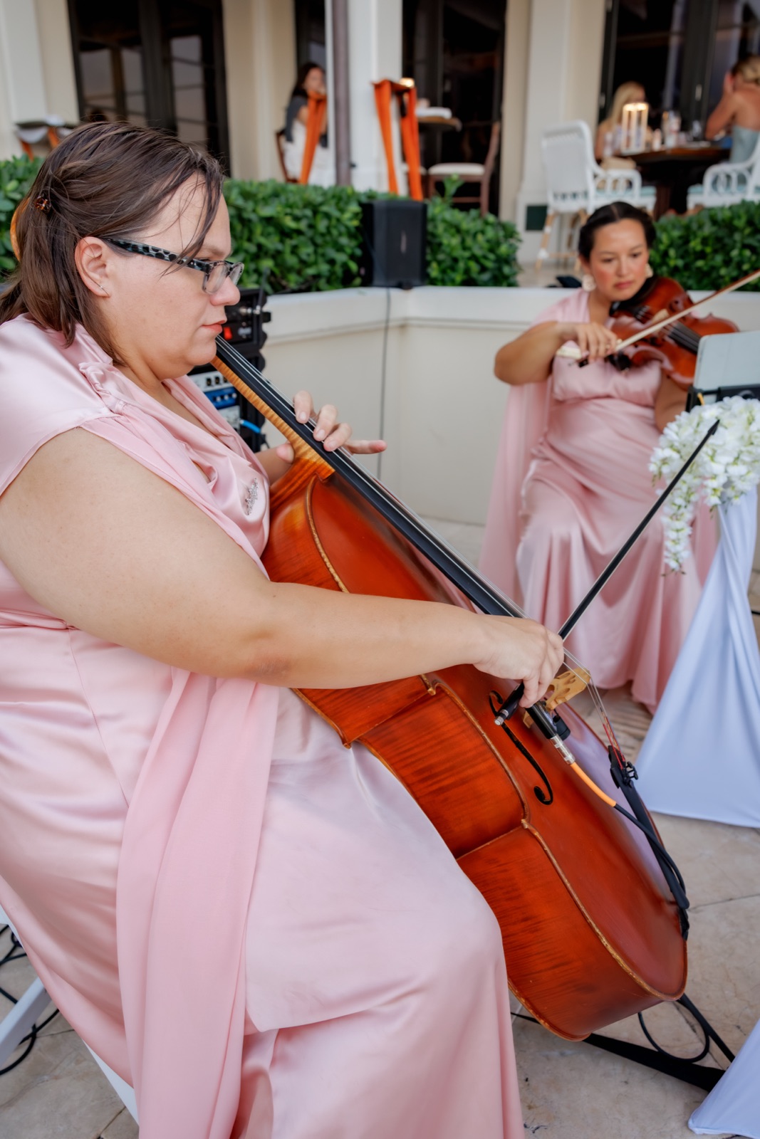Cellist and Violinist in matching pink peforming at a John's Island Club Wedding in Vero Beach