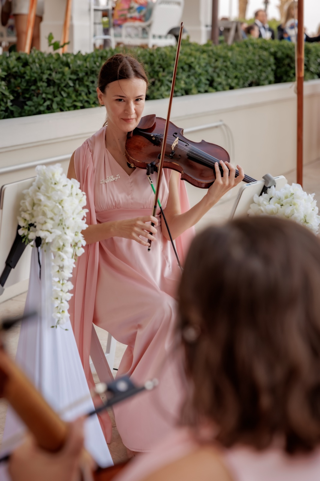 Violinist at John's Island Club Wedding dressed in pink about to perform
