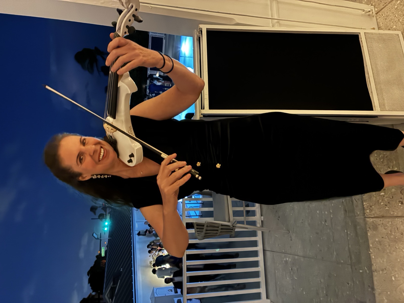 Electric Violinist of Luxe Harmony playing her violin, offering information about wedding violinist prices.